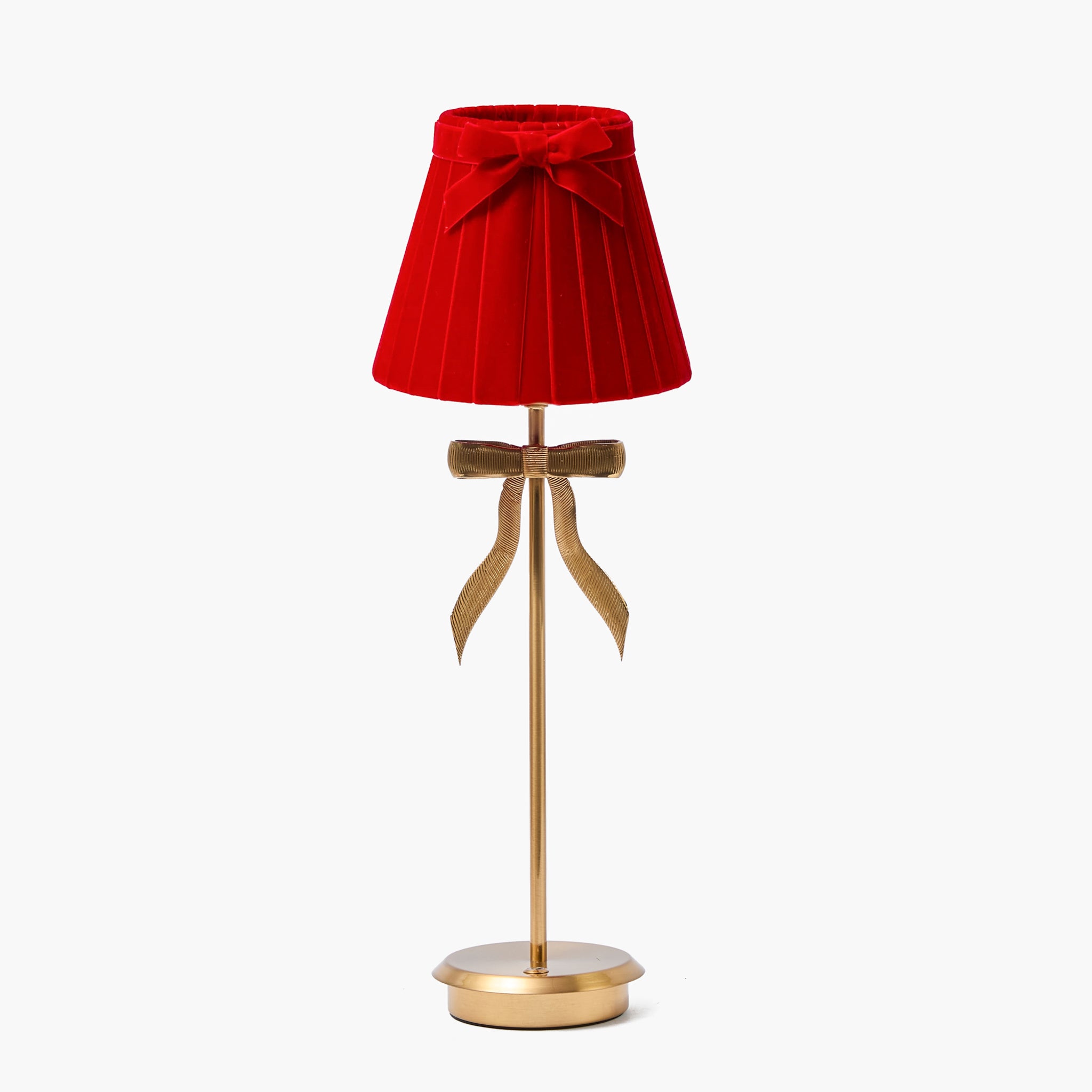 lamp with a red shade and gold base on a white background