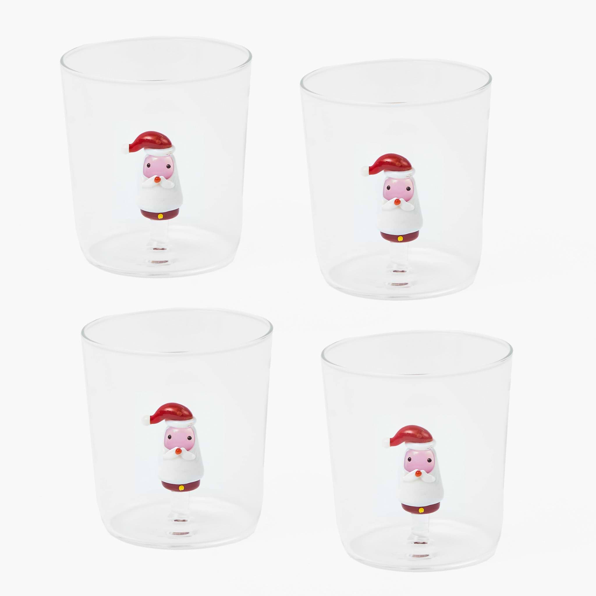 Four clear glasses with cartoon snowman designs on a white background
