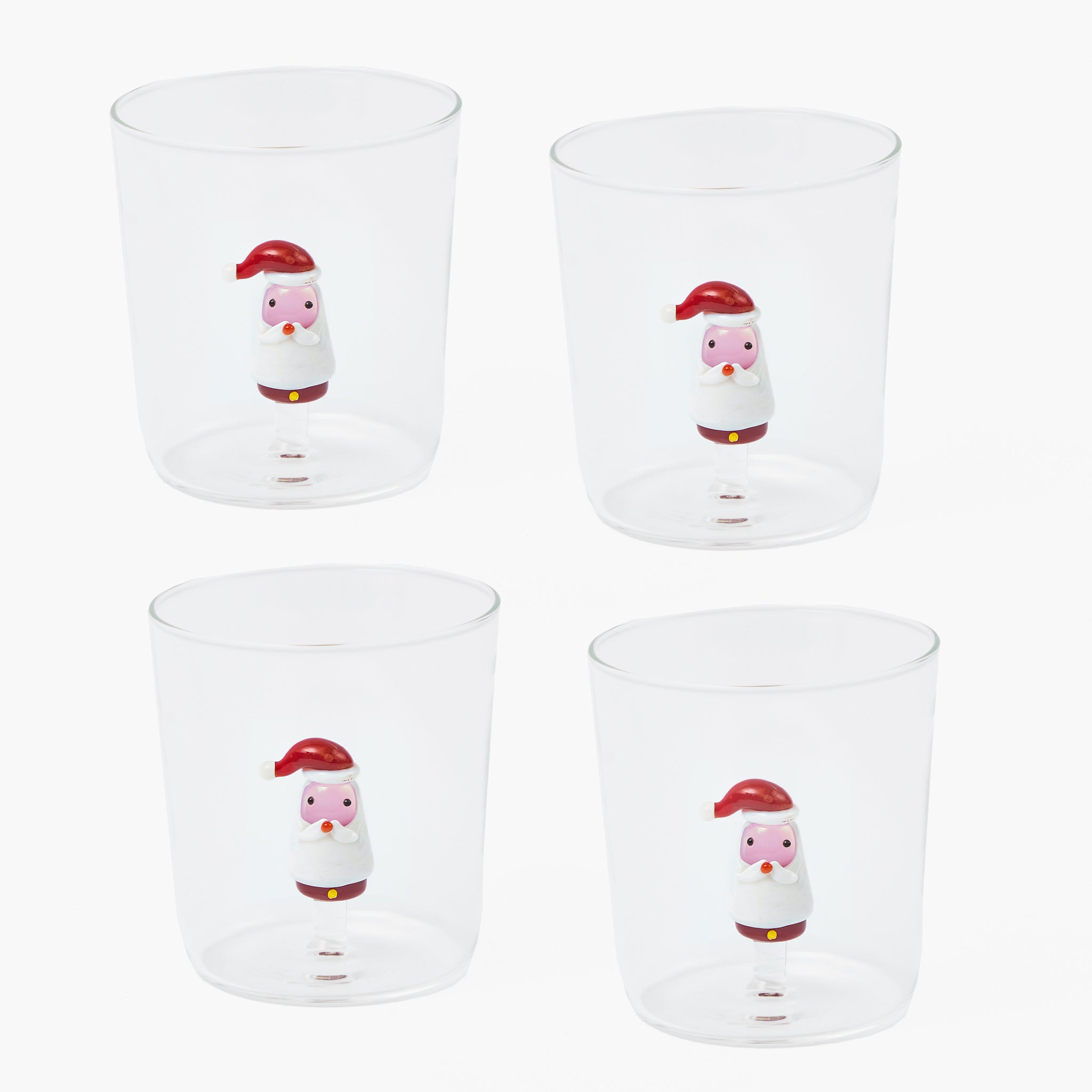Four clear glasses with cartoon snowman designs on a white background
