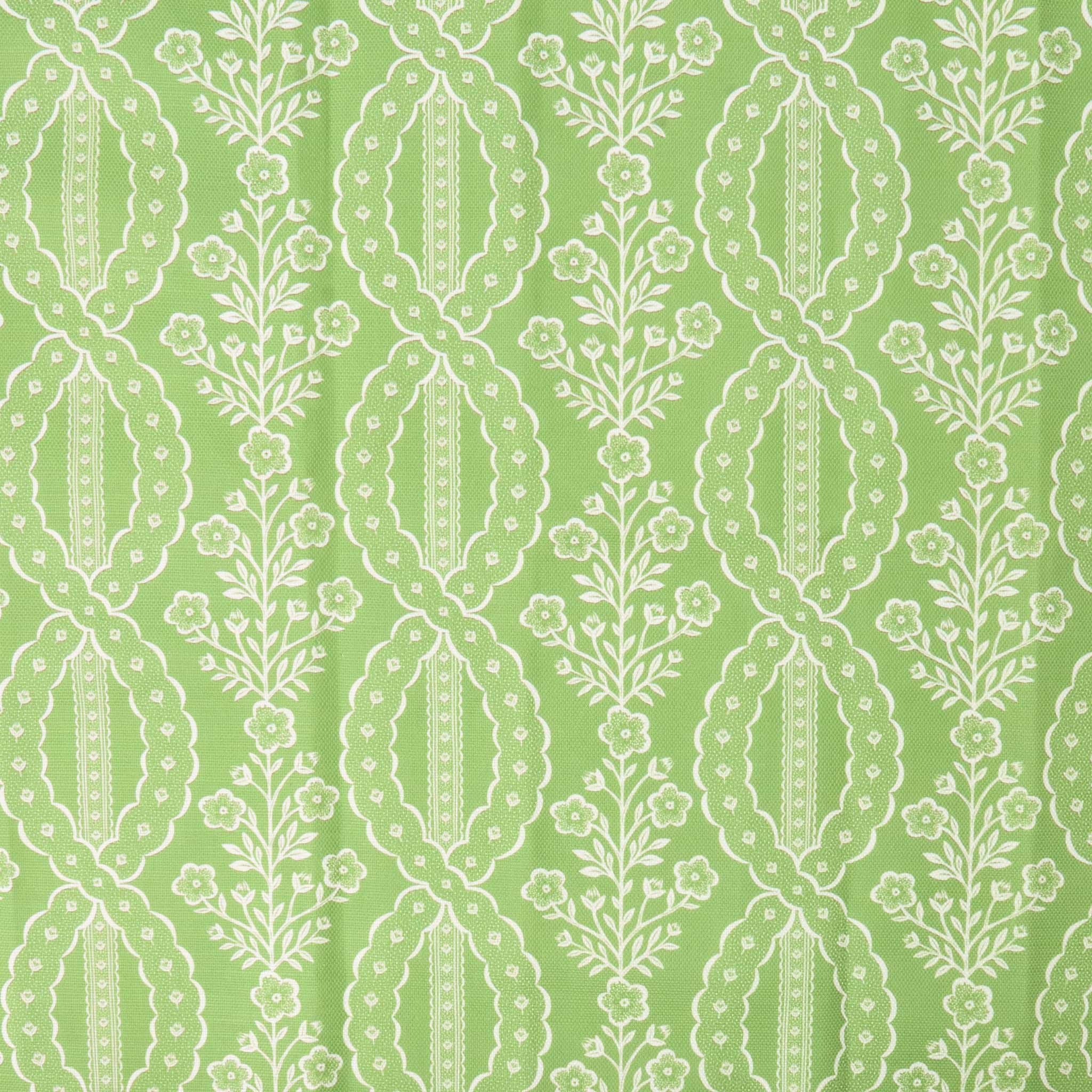 White floral and leaf pattern on a green background