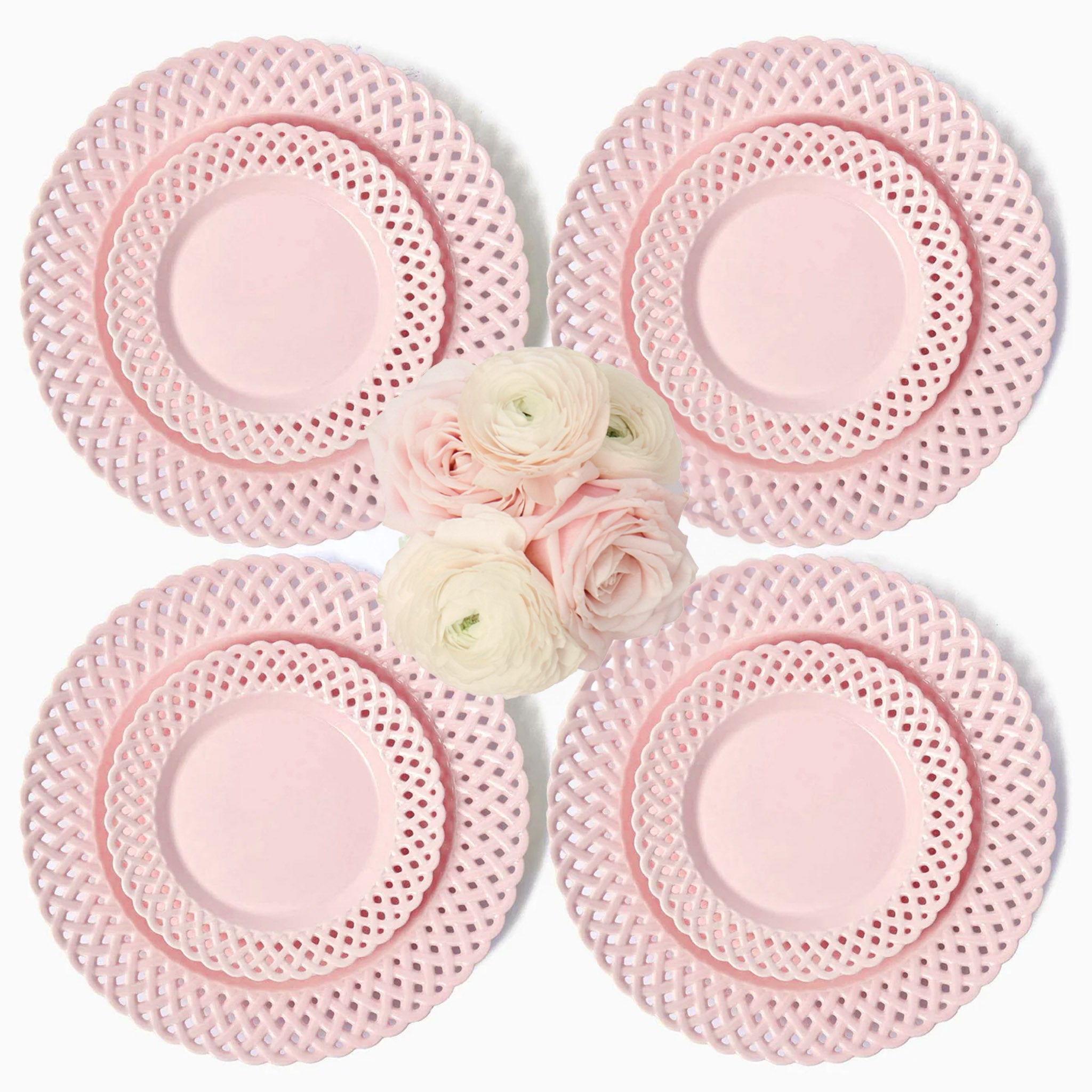 Set of four pink lace plates with a small bouquet of flowers in the center on a white background