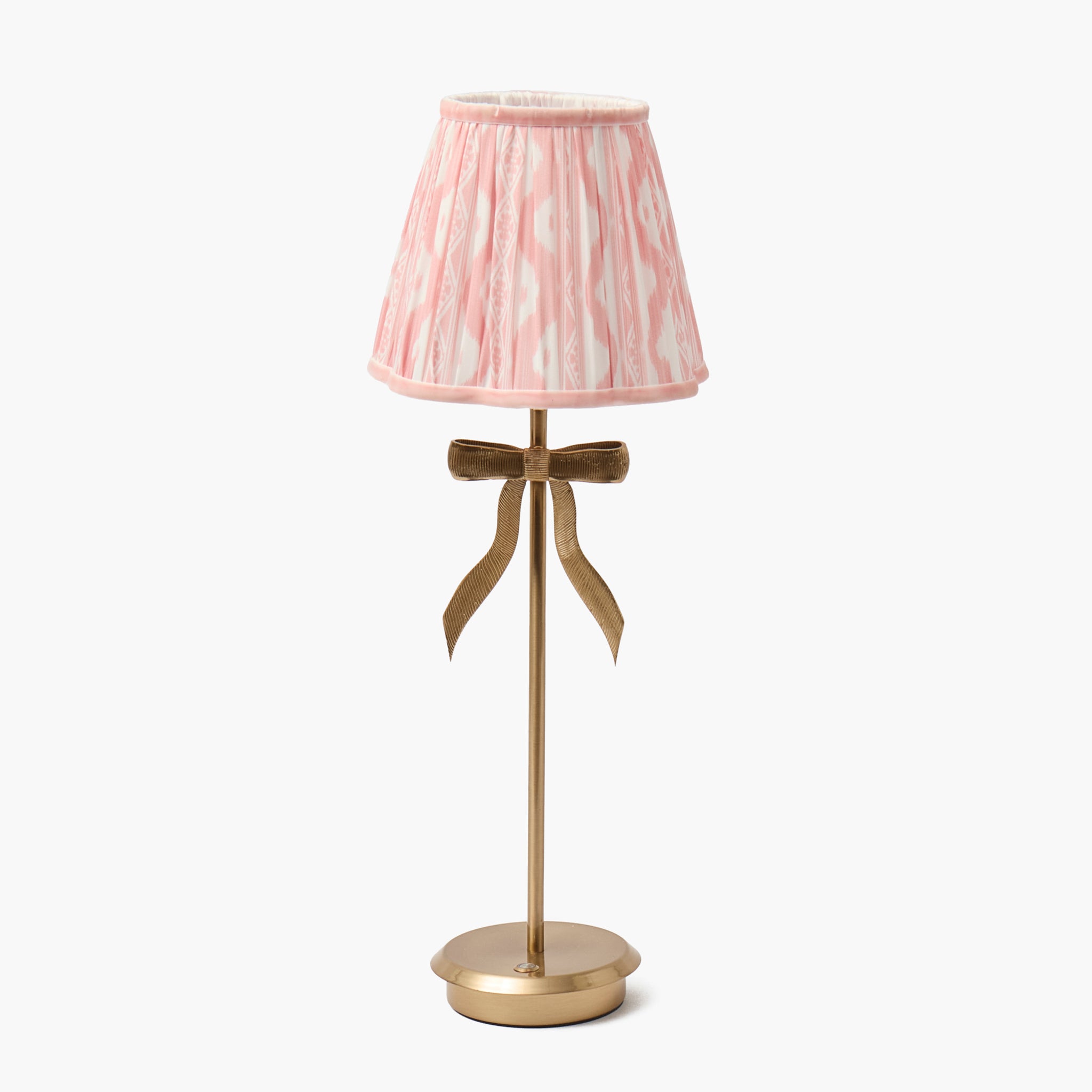 Tall lamp with a pink striped shade and gold base on a white background