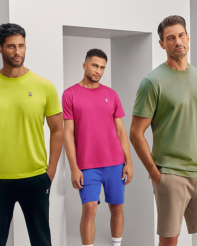 3 models wearing psycho bunny's classic tee in neon yellow, pink and khaki standing