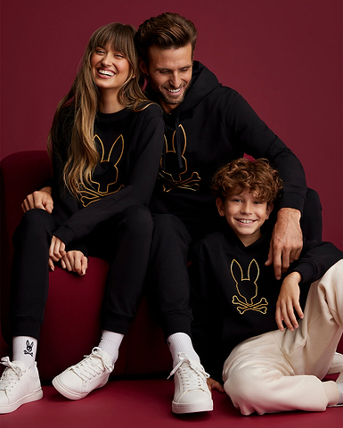 family wearing the same outfit in a crimson background