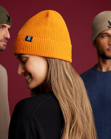 three models, two men and a woman wearing hats