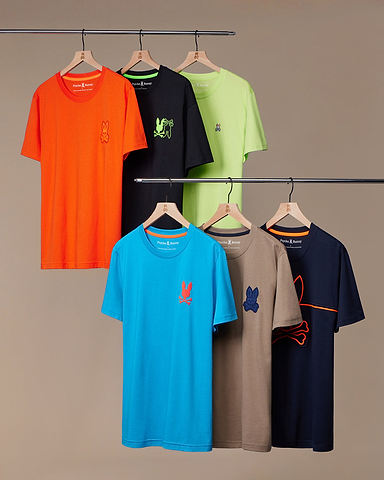 6 psycho bunny's tees hanging on a beige font