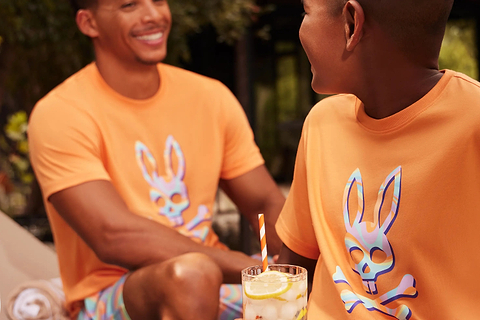 a man a kid wearing matching outfits playing together