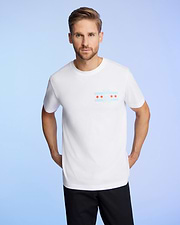 A person with light brown hair and a beard is wearing the Psycho Bunny MENS CHICAGO CITY TEE - B6U551W1PC in soft Pima cotton. The shirt has a graphic design of red stars and blue stripes on the chest against a light blue gradient background.