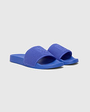 Royal Blue Kids Knit Slides featuring a textured knitted strap with an embossed Psycho Bunny skull logo, and a smooth sole.
