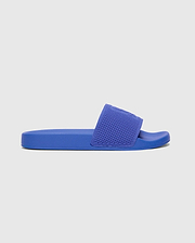 Vibrant royal blue Kids Knit Slides featuring a comfortable, textured knit strap with an embossed Psycho Bunny skull logo, set on a durable, subtly textured sole.