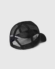 The Psycho Bunny KIDS BUNNY PATCH TRUCKER CAP (B0A965C200) is a black kids' hat with breathable mesh panels, an adjustable snapback, and "PSYCHO BUNNY" embroidered in white above the back opening.