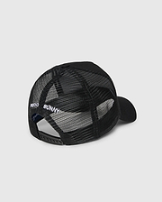 The Psycho Bunny KIDS BUNNY PATCH TRUCKER CAP (B0A965C200) is a black kids' hat with breathable mesh panels, an adjustable snapback, and "PSYCHO BUNNY" embroidered in white above the back opening.