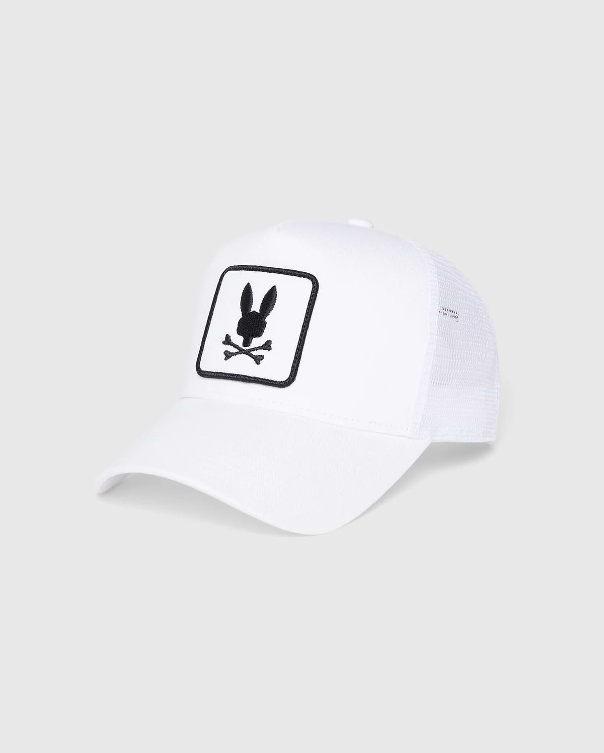 The Psycho Bunny Kids Bunny Patch Trucker Cap (B0A965C200) is a white mesh baseball cap featuring the iconic rabbit head above crossed bones emblem. This hat beautifully blends classic style with a playful design.