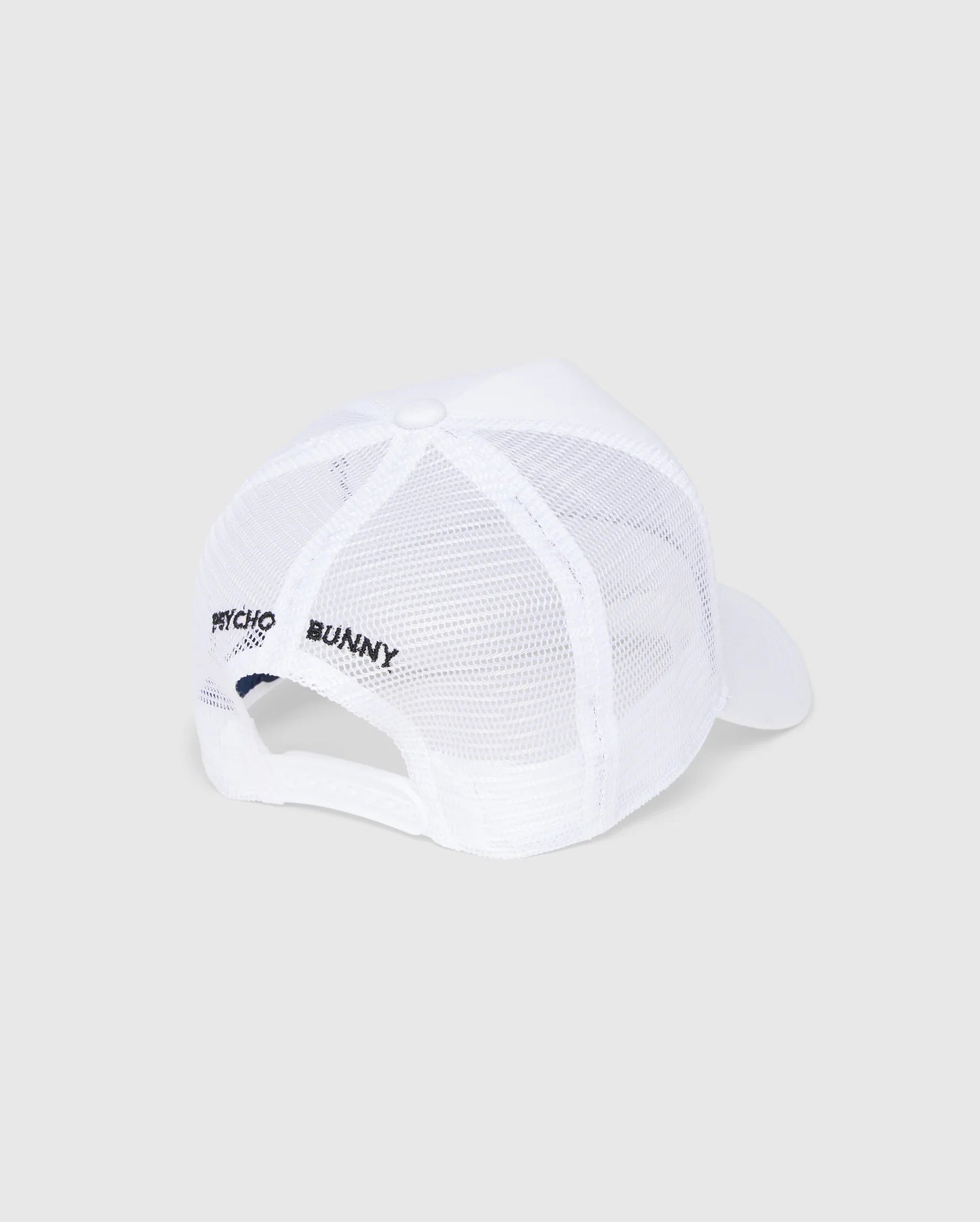 The KIDS BUNNY PATCH TRUCKER CAP - B0A965C200 by Psycho Bunny is a white mesh trucker cap with the iconic Bunny logo patch. It features "Psycho Bunny" text on the side, a white brim, snapback closure, and a top button, all set against a light gray background.