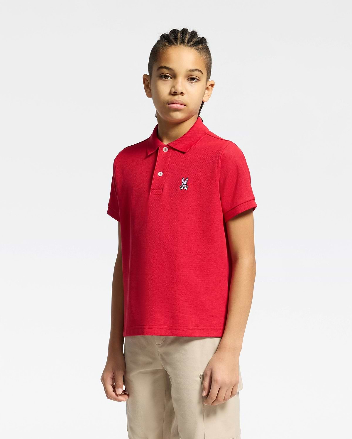 kids classic pique polo shirt in vibrant red, featuring a classic fit, two-button placket, and a small embroidered white Psycho Bunny skull logo on the left chest.