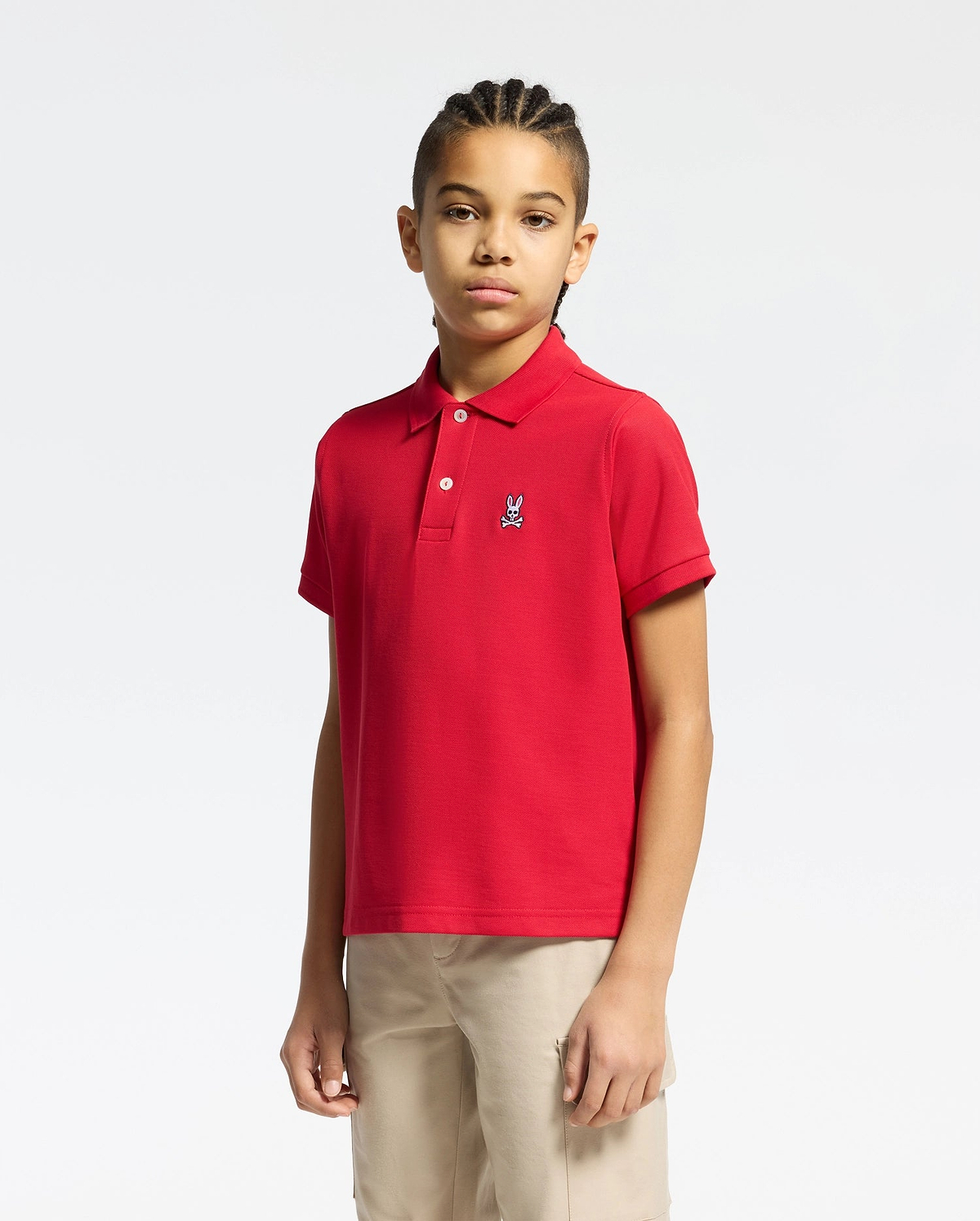 kids classic pique polo shirt in vibrant red, featuring a classic fit, two-button placket, and a small embroidered white Psycho Bunny skull logo on the left chest.