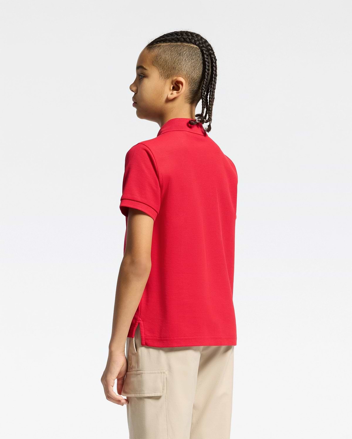 Vibrant red kids classic pique polo shirt by Psycho Bunny, showcasing a classic fit, textured pique fabric, short sleeves, ribbed collar, and subtle side vents.