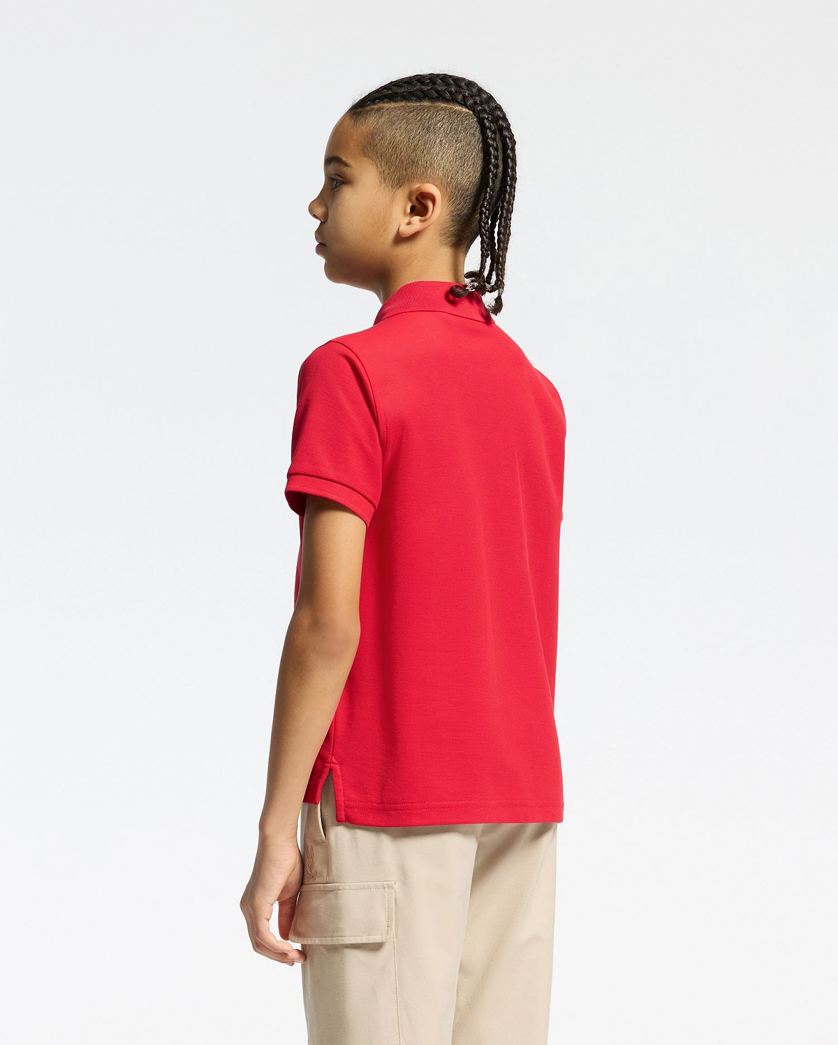 Vibrant red kids classic pique polo shirt by Psycho Bunny, showcasing a classic fit, textured pique fabric, short sleeves, ribbed collar, and subtle side vents.