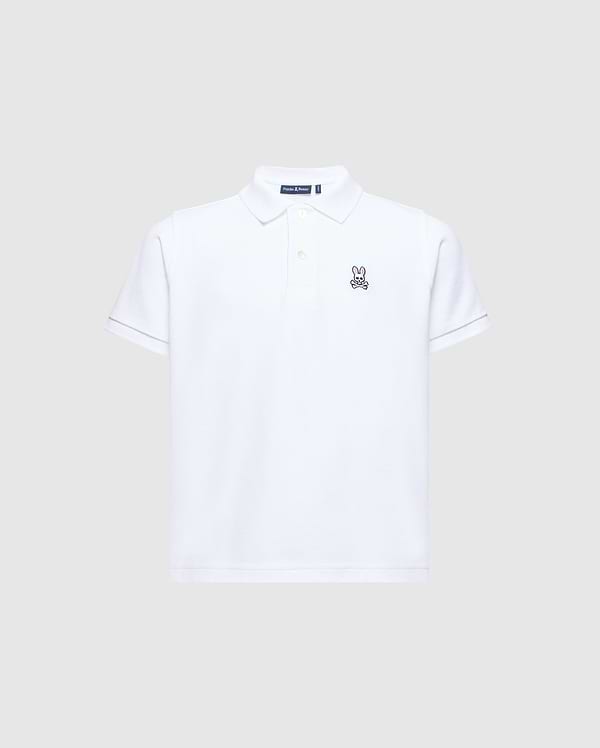 The Psycho Bunny Kids Classic Pique Polo Shirt (B0K001CRPC) is a white short-sleeved polo shirt made from soft Pima cotton. It features an embroidered rabbit logo on the left chest and has a classic collar with a button-up placket, all set against a light grey background.