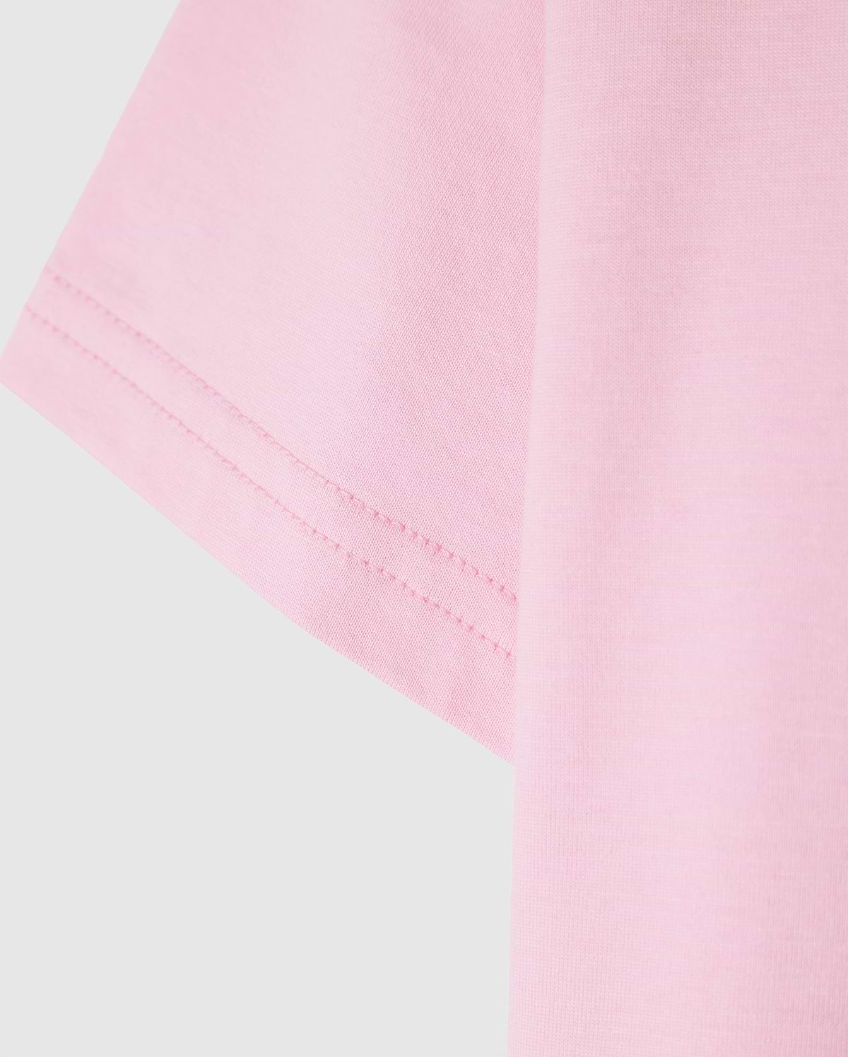 Close-up of the Psycho Bunny KIDS CLASSIC CREW NECK TEE - B0U014CRPC in pink, featuring visible sleeve stitching. Made from 100% Pima cotton for a soft and well-sewn finish, it's a high-quality choice perfect for back-to-school outfits.