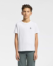 A young person with short dark hair, wearing a Psycho Bunny KIDS CLASSIC CREW NECK TEE - B0U014CRPC in crisp white 100% Pima cotton with the Classic Psycho Bunny embroidered logo, stands against a white background. They pair it with gray pants and maintain a neutral expression while facing forward.