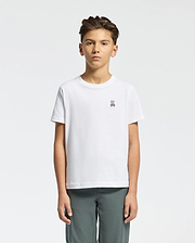A young person with short dark hair, wearing a Psycho Bunny KIDS CLASSIC CREW NECK TEE - B0U014CRPC in crisp white 100% Pima cotton with the Classic Psycho Bunny embroidered logo, stands against a white background. They pair it with gray pants and maintain a neutral expression while facing forward.
