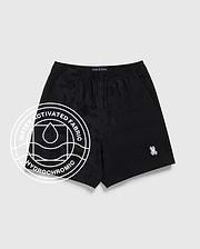 The Psycho Bunny KIDS MALTA HYDROCHROMIC SWIM TRUNK (B0W321B2SW) features a black camo pattern, white Psycho Bunny logo on the left leg, and a circular “Water Activated Fabric Hydrochromic” graphic, shown on a light gray background.
