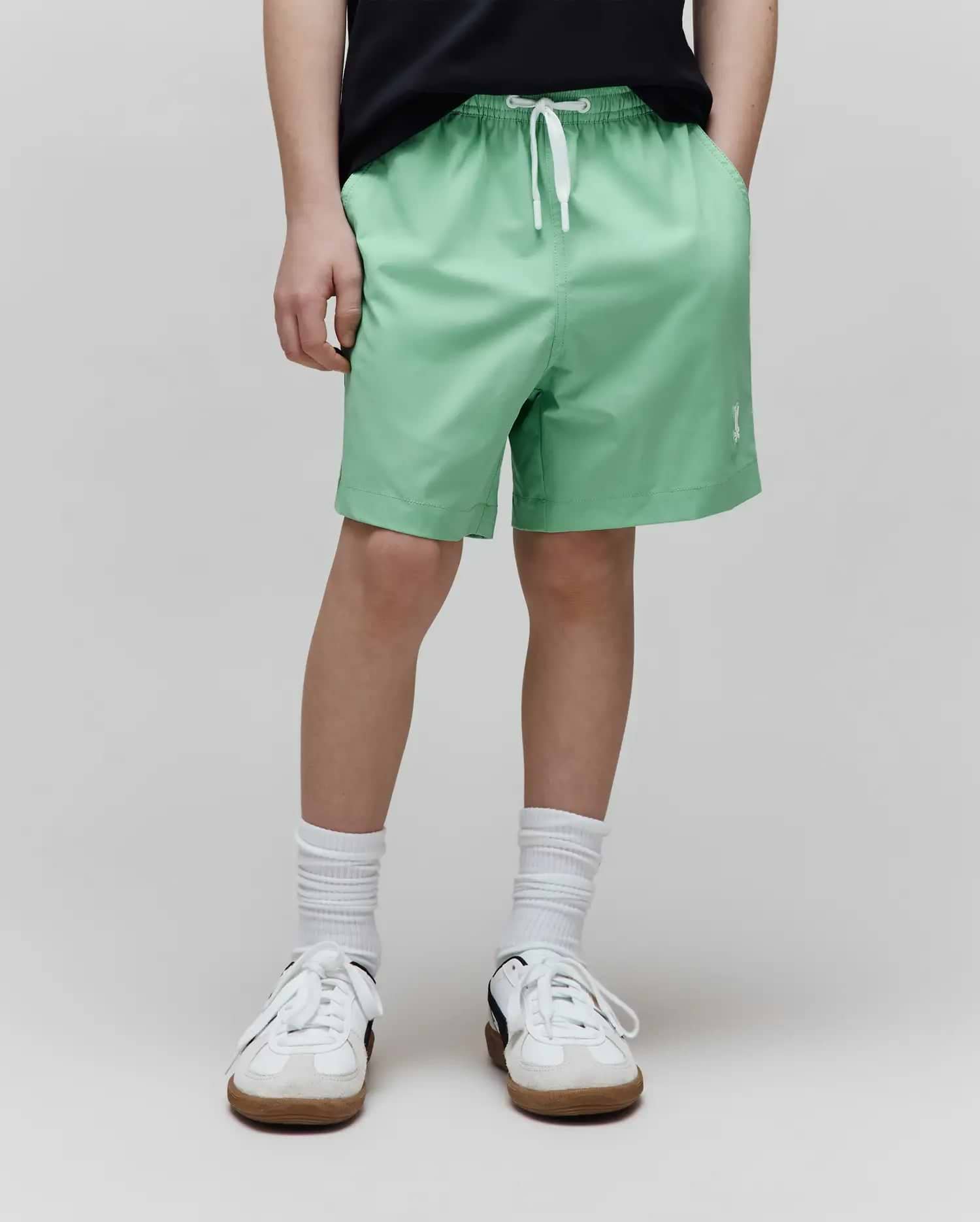 Kids Samos Hydrochromic Printed Swim Trunk, mint green, relaxed fit, with elastic waistband, white drawstring, side pockets, and a small white embroidered Psycho Bunny skull logo on the lower left leg.