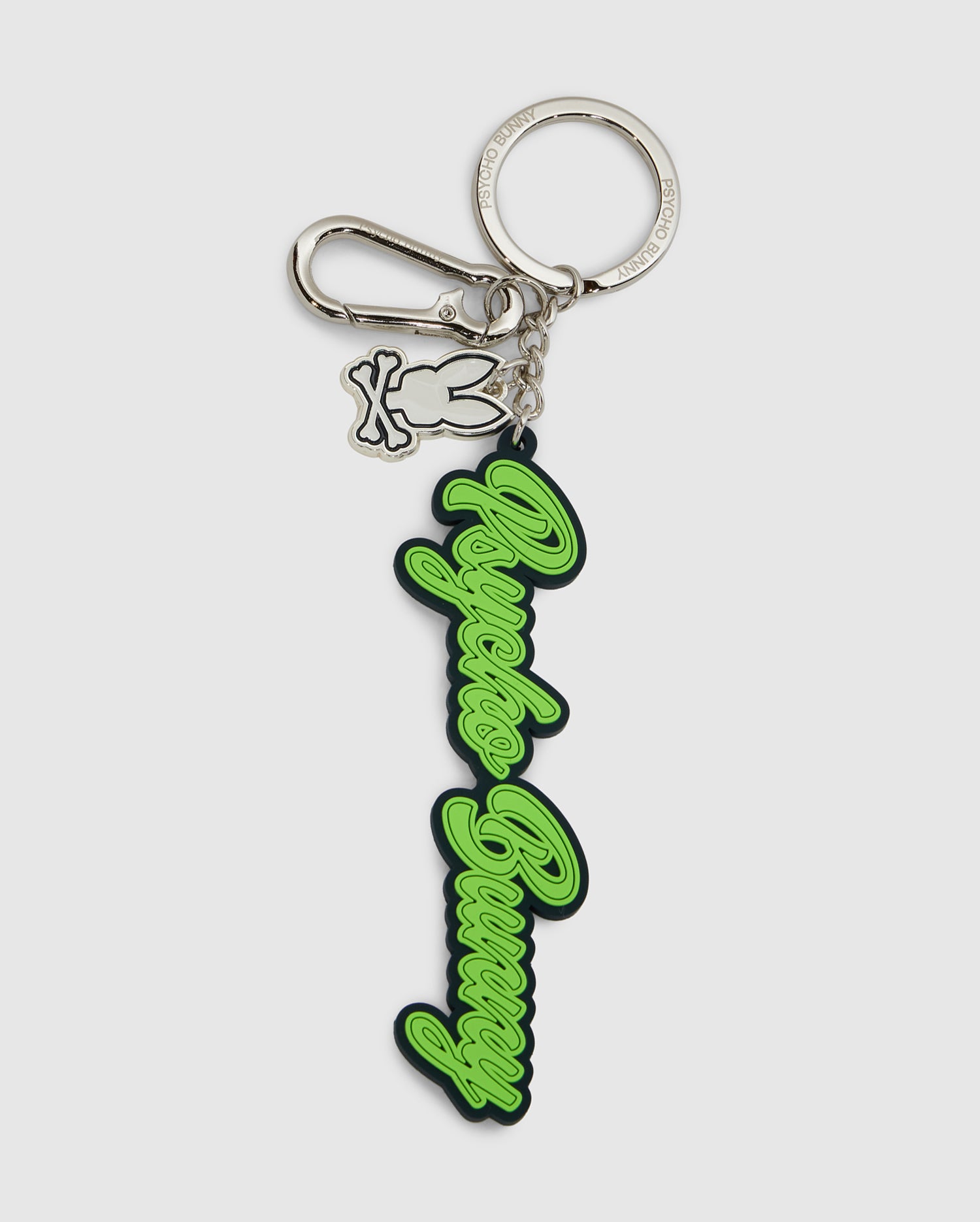 The Psycho Bunny SILICONE KEYCHAIN - B6A373E200 features a silver metal clasp, bunny-shaped charm, and a green and black rubber tag—perfect for daily use or any Psycho Bunny fan.