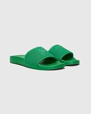 Vibrant Kelly green Mens Knit Slides, a premium streetwear design, featuring a prominent textured knit strap with a large embossed Psycho Bunny skull logo, and a comfortable, smooth monochromatic sole.