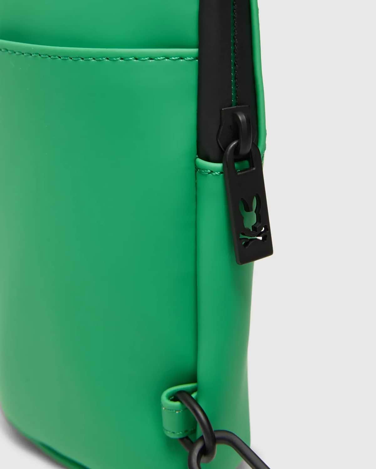 Mens Rubberized Crossbody in bright green with a smooth, rubberized finish, featuring a black zipper, hardware, and a small Psycho Bunny skull logo cutout on the zipper pull.
