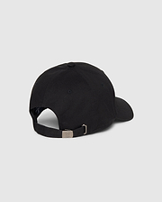 This image showcases the Psycho Bunny Men's Classic Baseball Cap (B6A816A1HT) in black, viewed from the rear. Made of 100% cotton, the cap features a curved brim, an adjustable strap with a metal buckle at the back, ventilation eyelets, and an embroidered Bunny logo. The background is plain white or light grey.