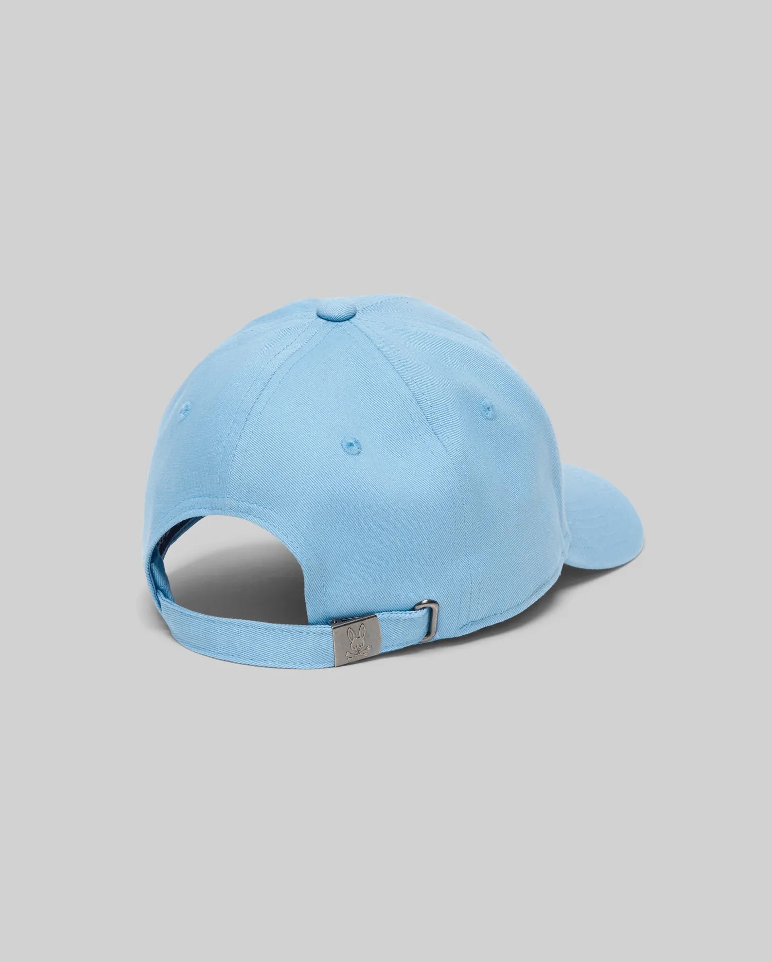 Mens Classic Baseball Cap in sky blue cotton twill, featuring an adjustable strap with a gunmetal buckle embossed with the small Psycho Bunny skull logo at the back.