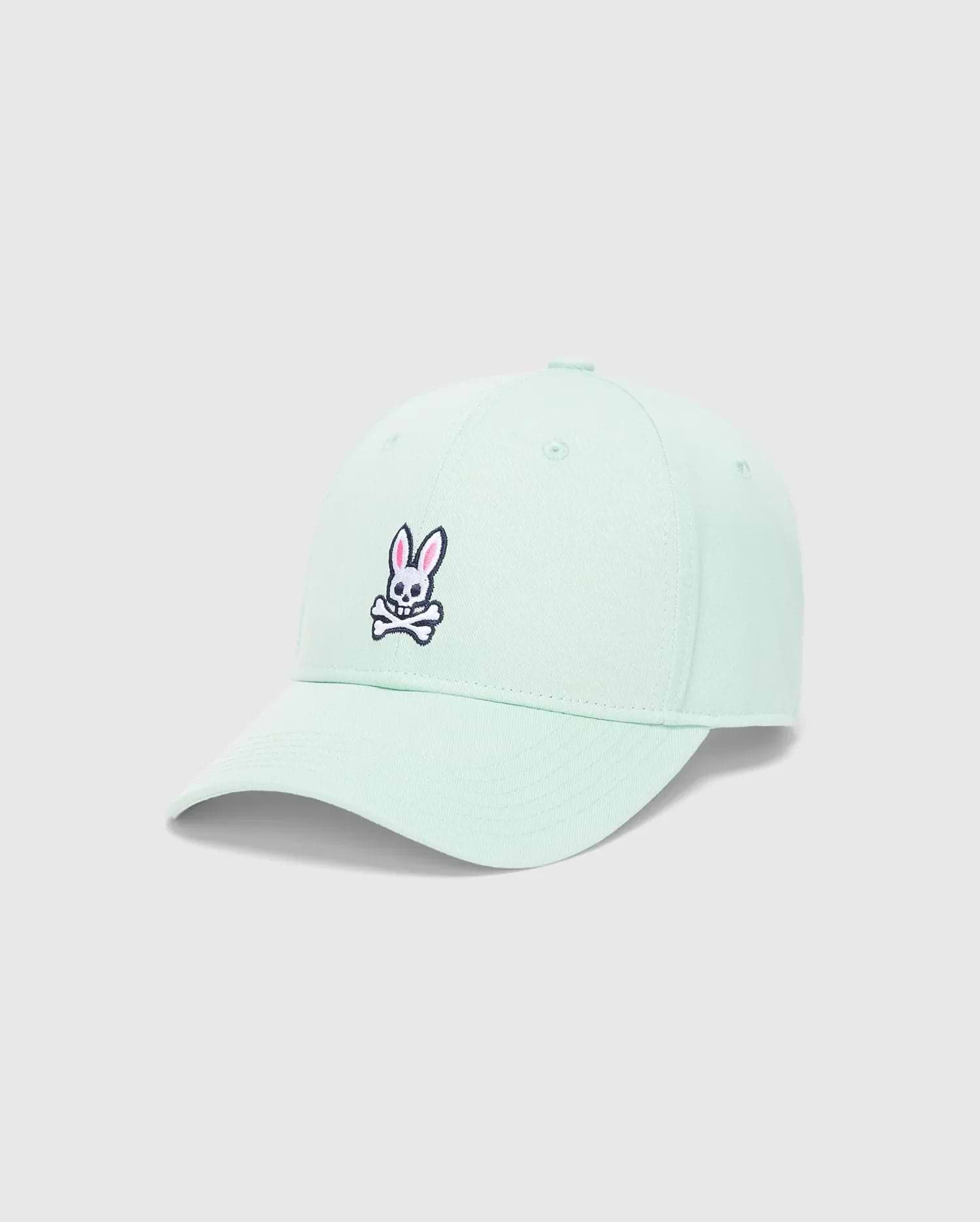 Light mint green Mens Classic Baseball Cap with a prominent embroidered pink and black Psycho Bunny skull logo on the front, featuring a classic cotton twill texture.