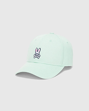 Light mint green Mens Classic Baseball Cap with a prominent embroidered pink and black Psycho Bunny skull logo on the front, featuring a classic cotton twill texture.