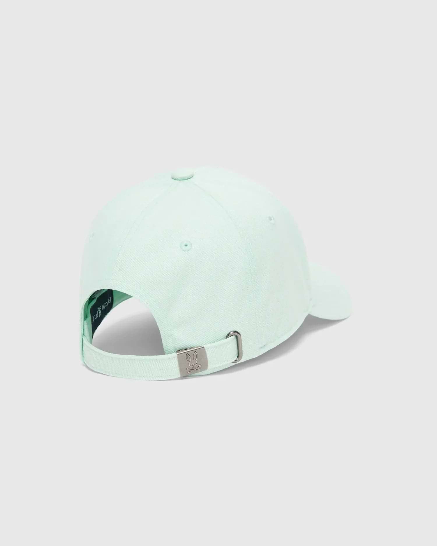 Mens Classic Baseball Cap in light mint green cotton twill, featuring an adjustable strap with a small engraved Psycho Bunny skull logo on the gunmetal buckle.