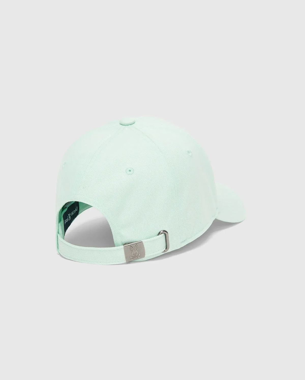 Mens Classic Baseball Cap in light mint green cotton twill, featuring an adjustable strap with a small engraved Psycho Bunny skull logo on the gunmetal buckle.