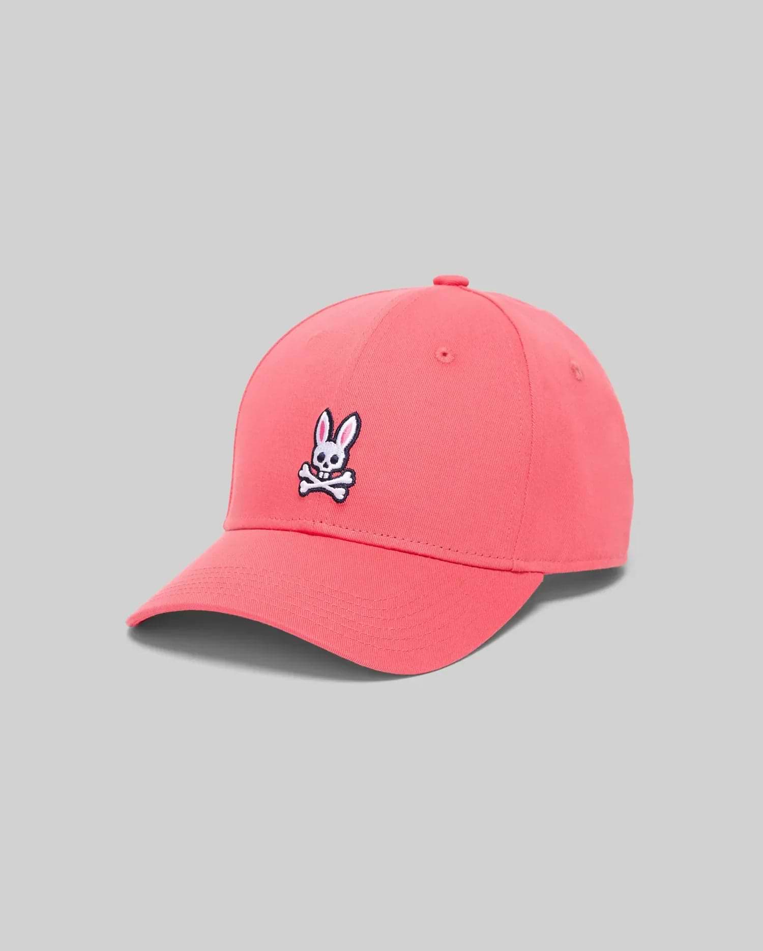 Mens Classic Baseball Cap in vibrant coral cotton twill, featuring a prominent embroidered white, black, and pink Psycho Bunny skull logo centered on the front. (2)