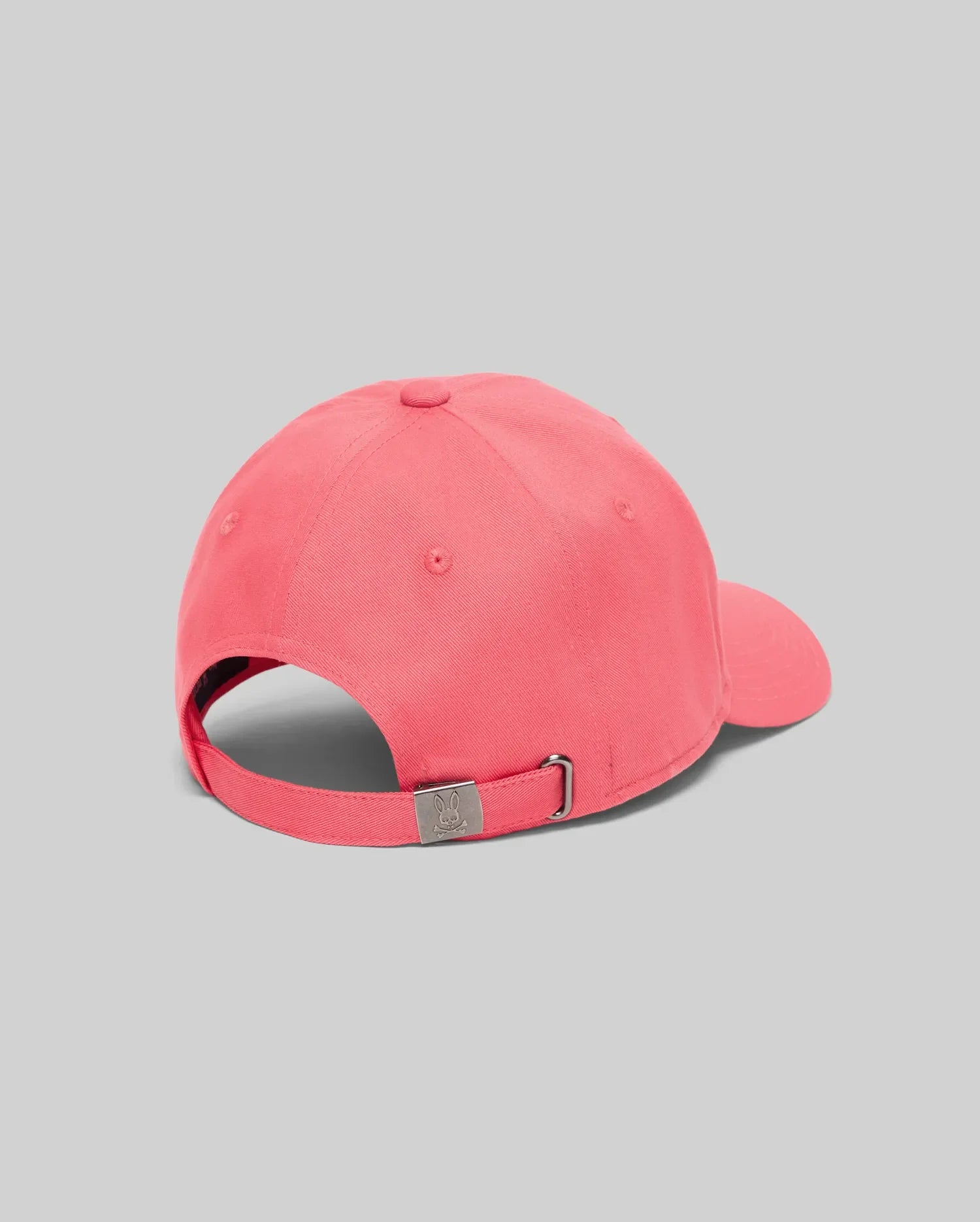 Mens Classic Baseball Cap in coral pink cotton twill, featuring an adjustable strap and a silver-tone metal buckle engraved with the iconic Psycho Bunny skull logo at the back. (4)