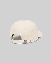 The Psycho Bunny MENS CLASSIC BASEBALL CAP (B6A816A1HT) in cream cotton is shown from the back, highlighting its adjustable strap with a metallic clasp against a plain gray background.