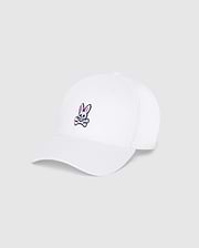 The Psycho Bunny MENS CLASSIC BASEBALL CAP - B6A816A1HT, in a classic white color, showcases an embroidered design featuring a cartoonish rabbit's head with pink ears and a skull motif, placed above a pair of crossbones on the front. Its adjustable fit ensures comfort, making this cap perfect for everyday wear against its plain light grey background.