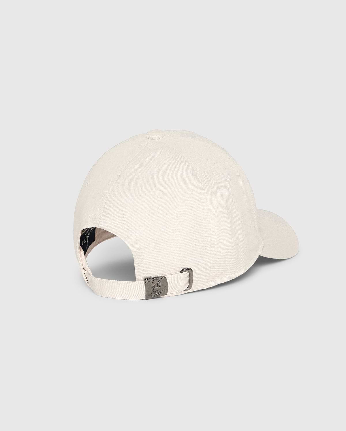 The Psycho Bunny MENS CLASSIC BASEBALL CAP - B6A816B200 is displayed from the back, revealing its adjustable strap with a metal buckle. Crafted from 100% cotton in light color, it symbolizes classic accessory style against a plain light-gray background.
