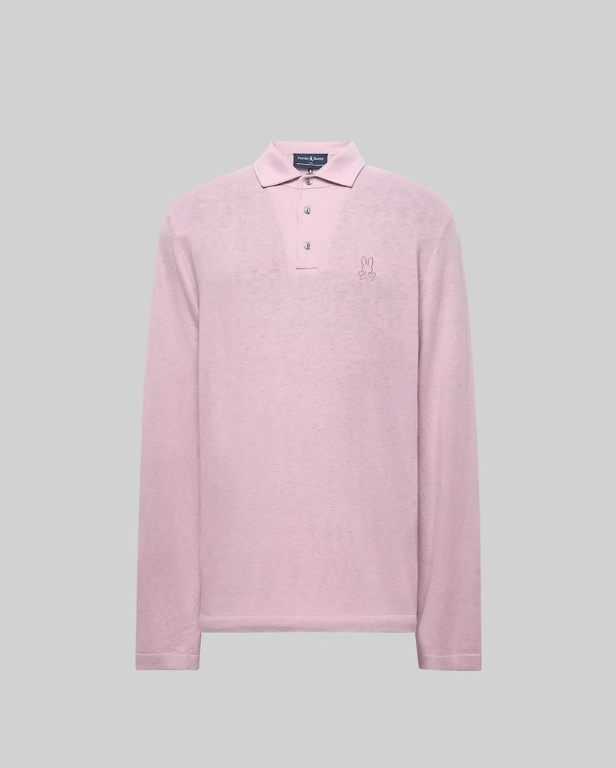 The Psycho Bunny MENS BRADSHAW POLO SWEATER (B6E835D200) is a long-sleeve, light pink merino wool polo with a collar, three mother of pearl buttons, and an embroidered bunny logo on the left chest, shown against a gray background. (5)