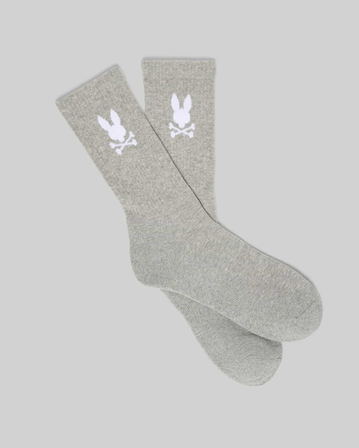 Pair of Grey Mens 3 Pack Sport Sock, featuring a soft knit texture and a prominent white knitted Psycho Bunny skull logo on the ankle cuff of each sock.