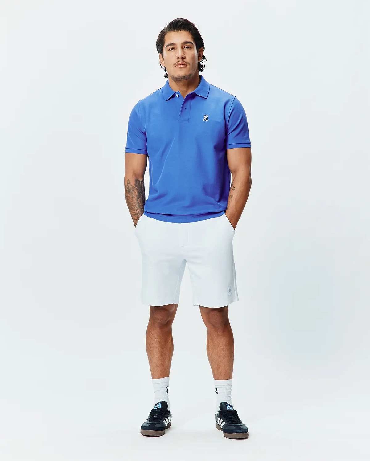 Mens Classic Pique Polo in vibrant royal blue, a classic fit design crafted from textured pique fabric, featuring a small, crisp white embroidered Psycho Bunny skull logo on the left chest.