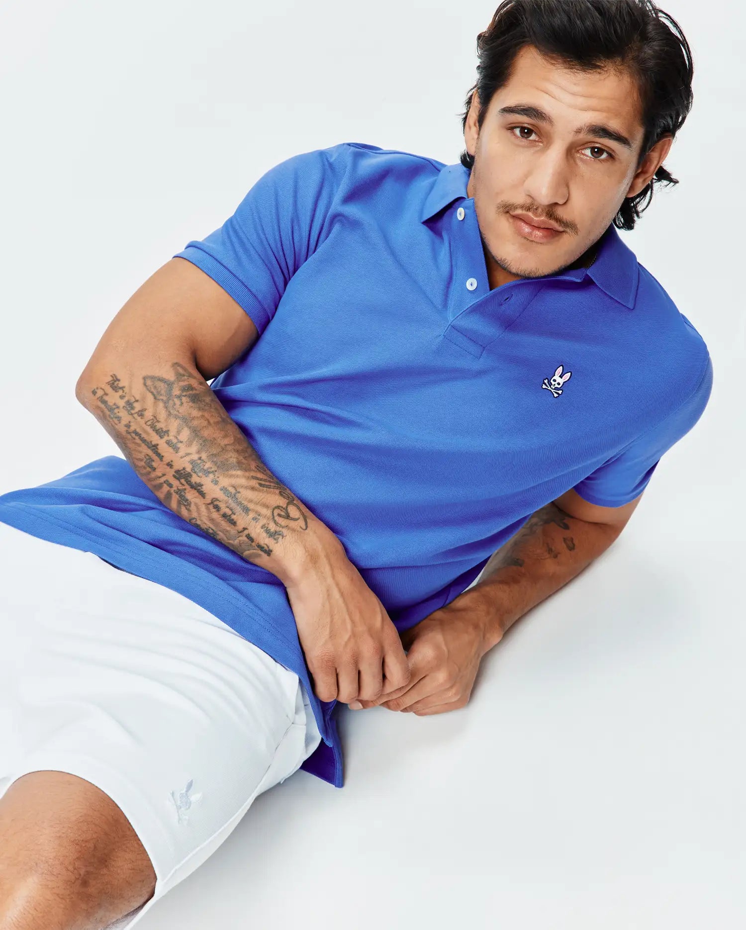 Mens Classic Pique Polo in vibrant royal blue, featuring a classic fit, textured pique knit fabric, and a small embroidered Psycho Bunny skull logo on the left chest with white buttons.