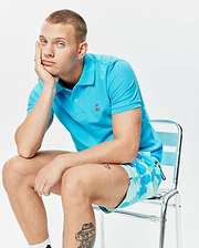Mens Classic Pique Polo in vibrant turquoise, featuring a classic fit, two-button placket, and a small embroidered Psycho Bunny skull logo on the left chest. (5)