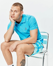 Mens Classic Pique Polo in vibrant turquoise, featuring a classic fit, two-button placket, and a small embroidered Psycho Bunny skull logo on the left chest. (5)