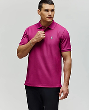 A man in a Psycho Bunny MENS CLASSIC PIQUE POLO - B6K001F200, featuring soft Pima cotton and an embroidered Bunny logo, paired with black pants, stands against a light gray background looking to his left.