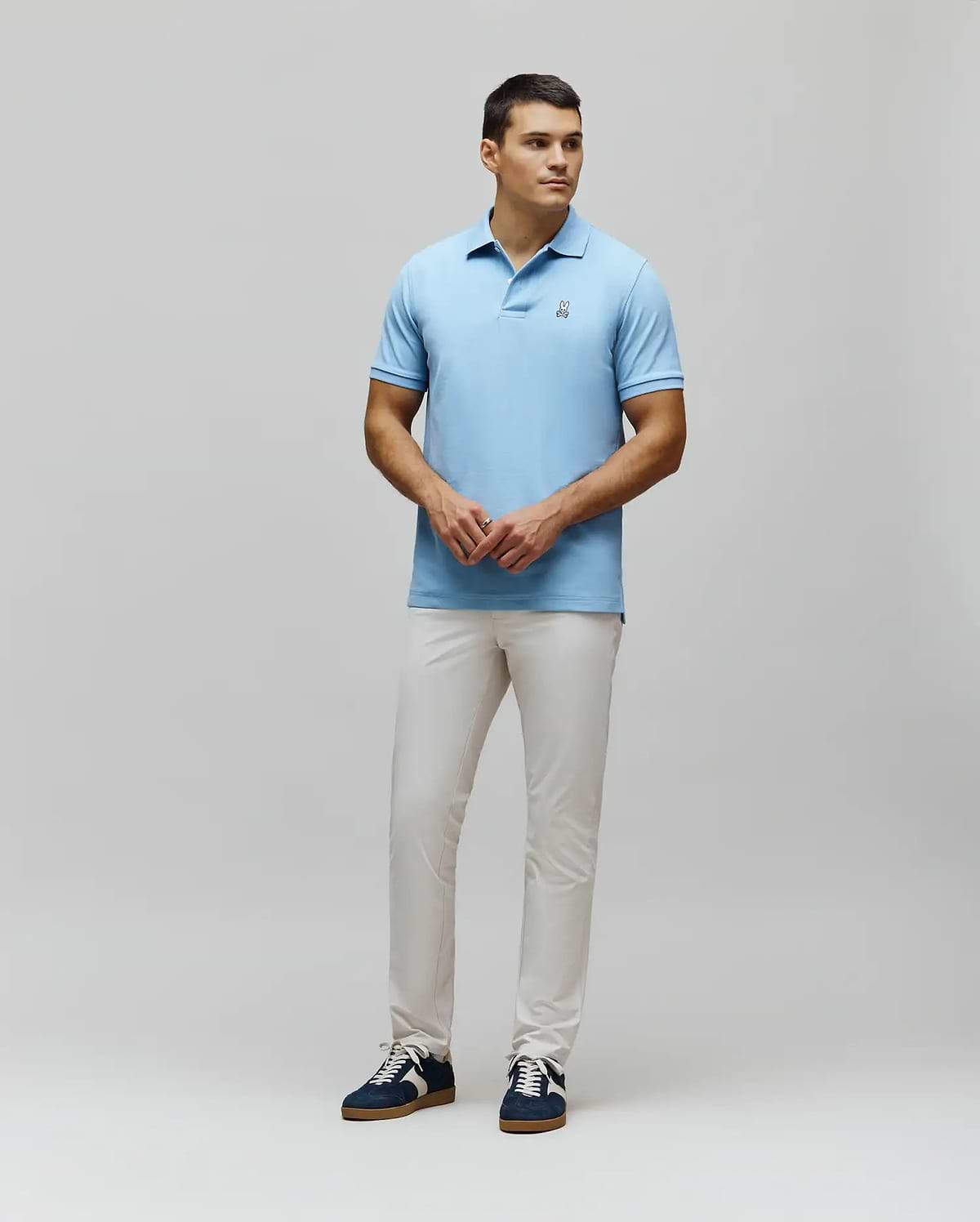 MENS CLASSIC PIQUE POLO in light blue, featuring a classic fit and pique knit texture. Small embroidered white Psycho Bunny skull logo on the left chest.